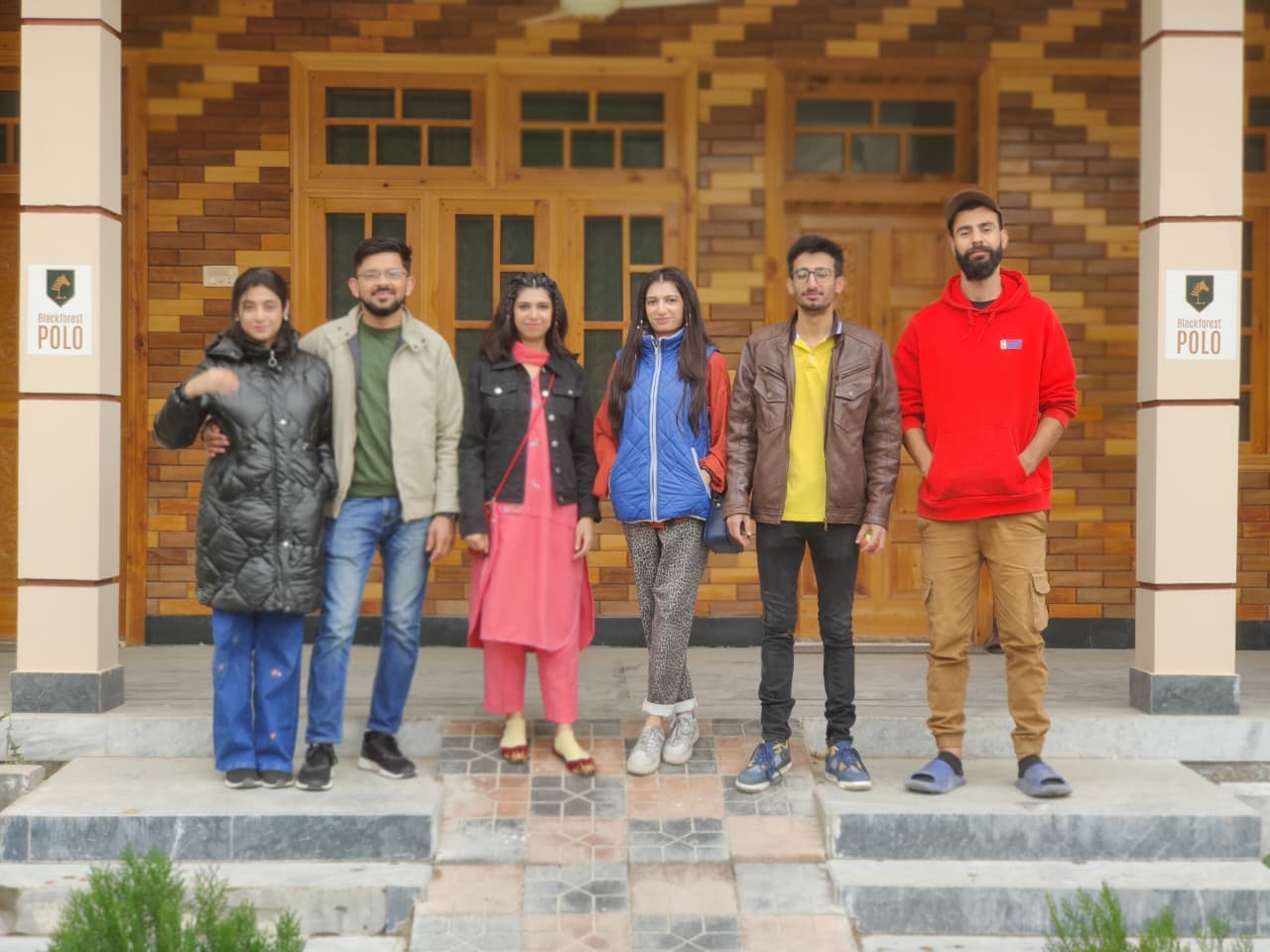 Guests posing outside the guest house entrance